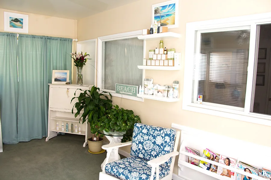 Beach-style waiting room at Molly's Sugar Shack with skincare shelves